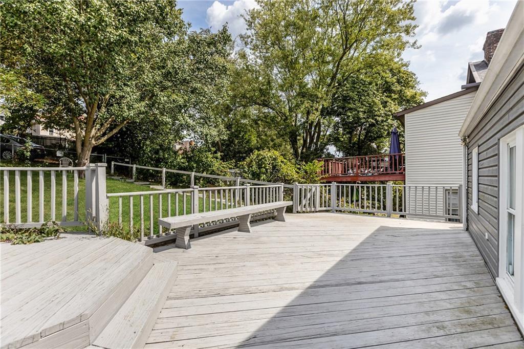 118 Oak Spring Road Canonsburg, PA 15317 - Photo 19 of 32 Expansive back deck with built-in seating provides the perfect space for outdoor entertaining. Surrounded by greenery, it’s a private retreat for relaxing or hosting gatherings.