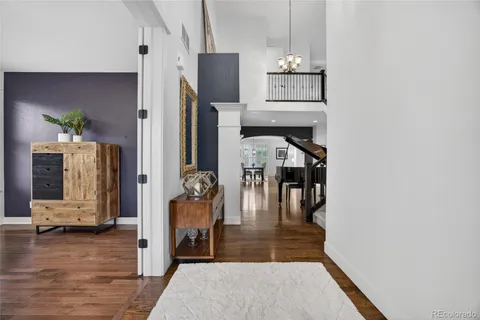 a kitchen with stainless steel appliances granite countertop a kitchen island hardwood floor sink and stove