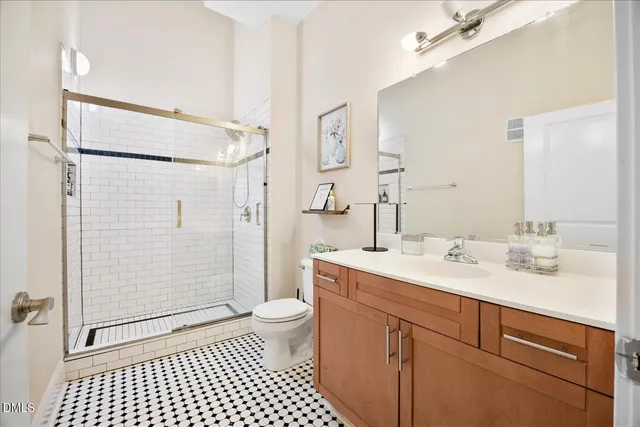 a spacious bathroom with a shower sink vanity mirror and toilet