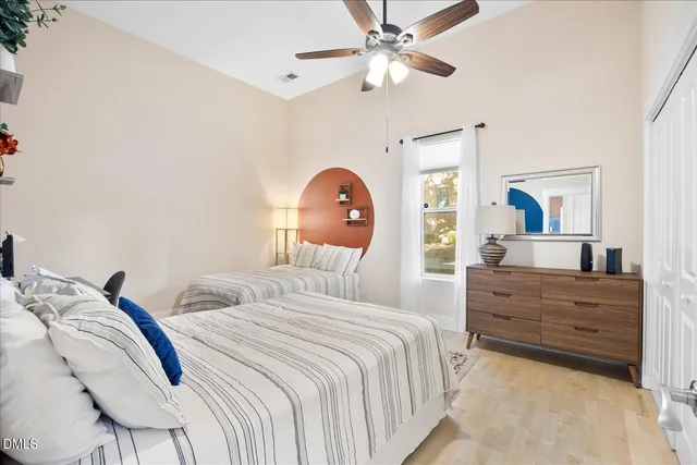 a bedroom with a bed and a chandelier