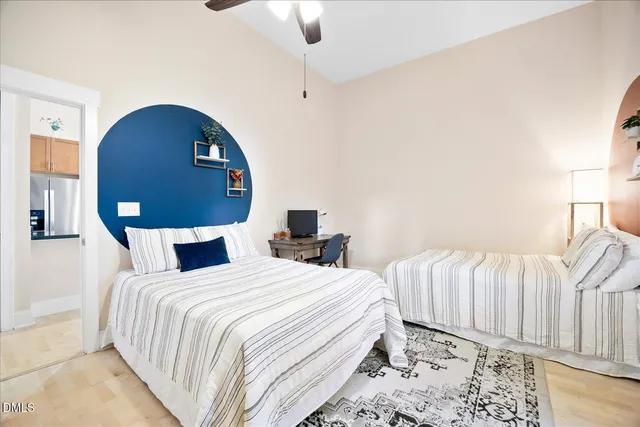 a bedroom with bed and a large mirror