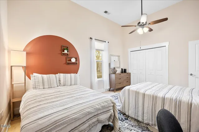 a bedroom with a bed and a chandelier