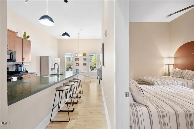 a bed room with a bed and a view of living room