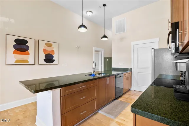 a kitchen with stainless steel appliances granite countertop a sink and stove