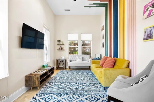 a living room with furniture and a flat screen tv