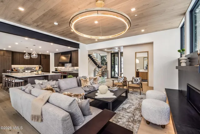 a living room with stainless steel appliances granite countertop furniture a fireplace and a large window