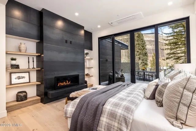 a bedroom with a large bed and a large window