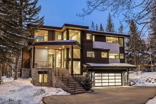 a view of a brick house with large windows