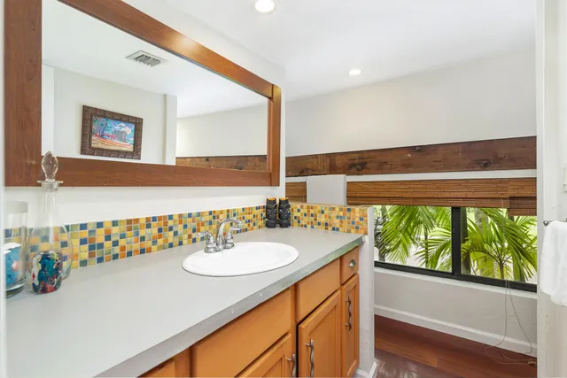 a bathroom with a sink a mirror and a shower