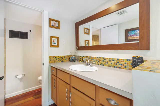 a bathroom with a shower and a glass door