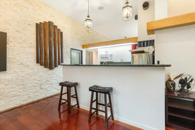 a kitchen with stainless steel appliances granite countertop a stove and a refrigerator