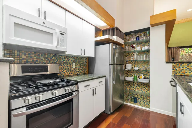 a kitchen with stainless steel appliances granite countertop a sink and a counter