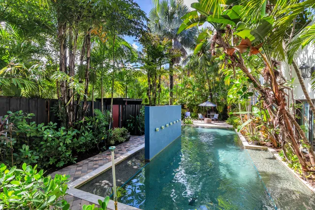 a view of backyard with swimming pool and outdoor seating