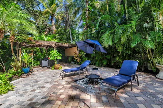 a view of a backyard with sitting area