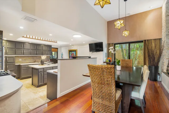 a kitchen with stainless steel appliances kitchen island granite countertop a stove and a view of living room
