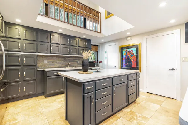 a view of a hallway with wooden floor and furniture
