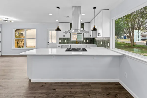 a view of kitchen with wooden floor and window