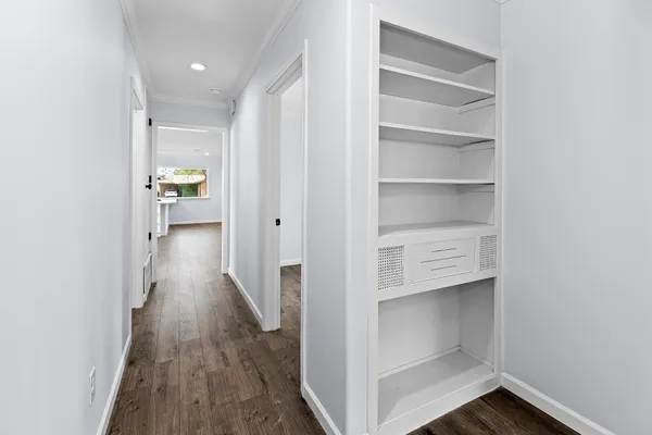 a view of a hallway with wooden floor