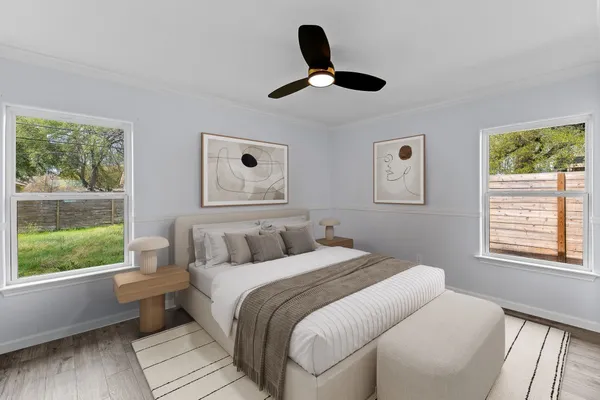 a bedroom with a large bed and a large window