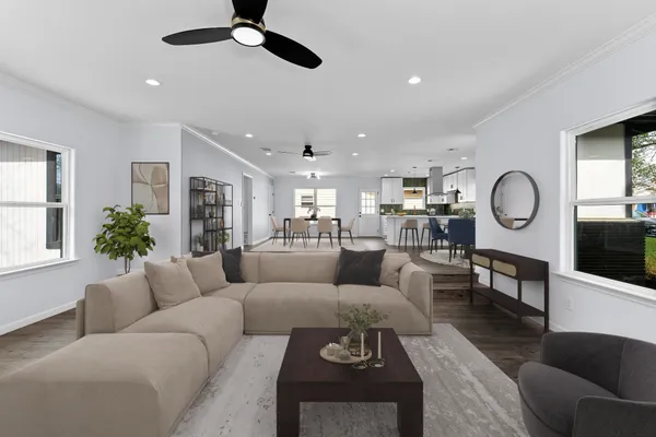 a living room with furniture kitchen view and a window