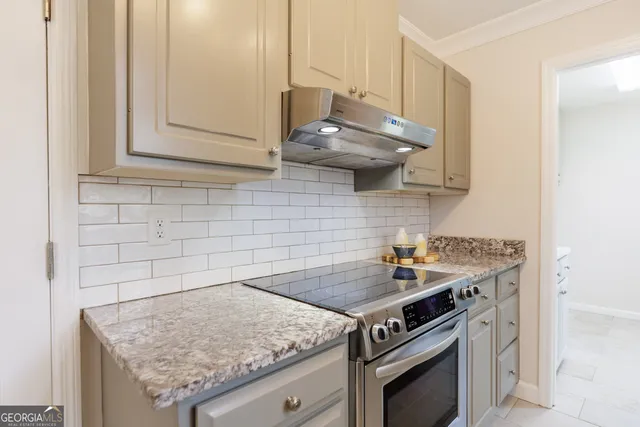 a kitchen with granite countertop a stove and a sink