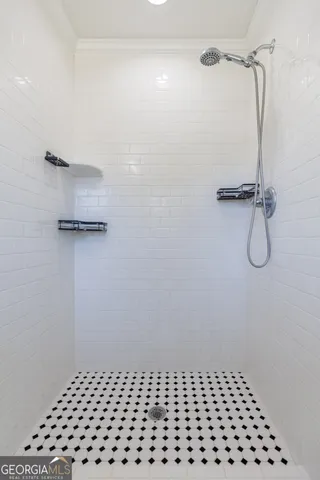 an empty room with wooden floor chandelier fan and windows