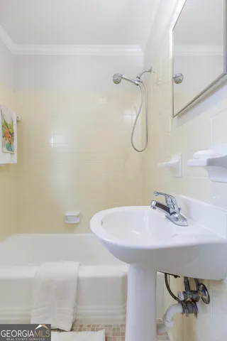 a bathroom with a sink and mirror