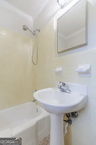 a bathroom with a sink and mirror