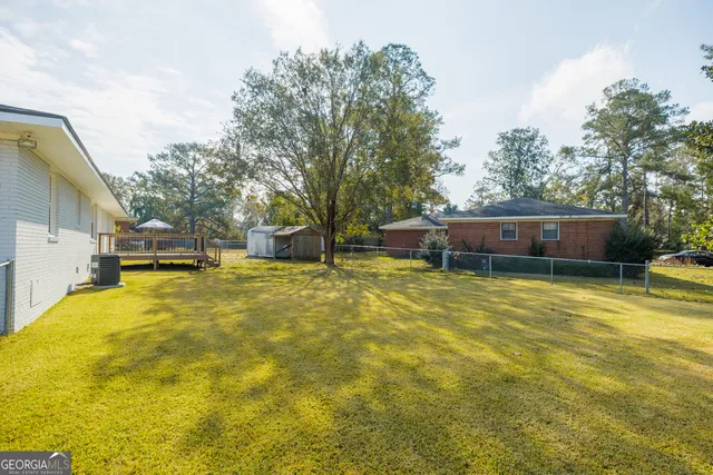 a front view of house with yard swimming pool and yard