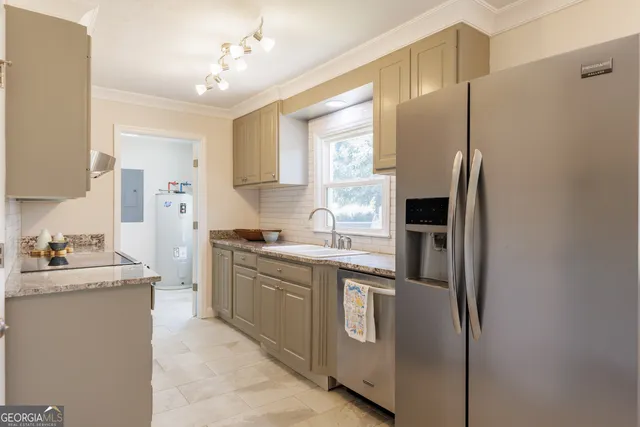 a kitchen with cabinets and stainless steel appliances