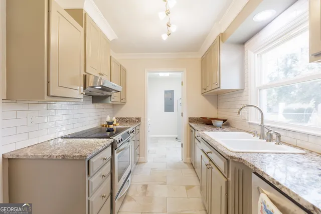 a kitchen with a sink stove and cabinets