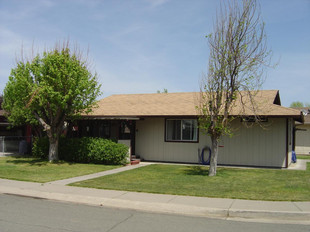 20694 Roff Way Burney, CA 96013 - Photo 1 of 2 a front view of a house with a garden