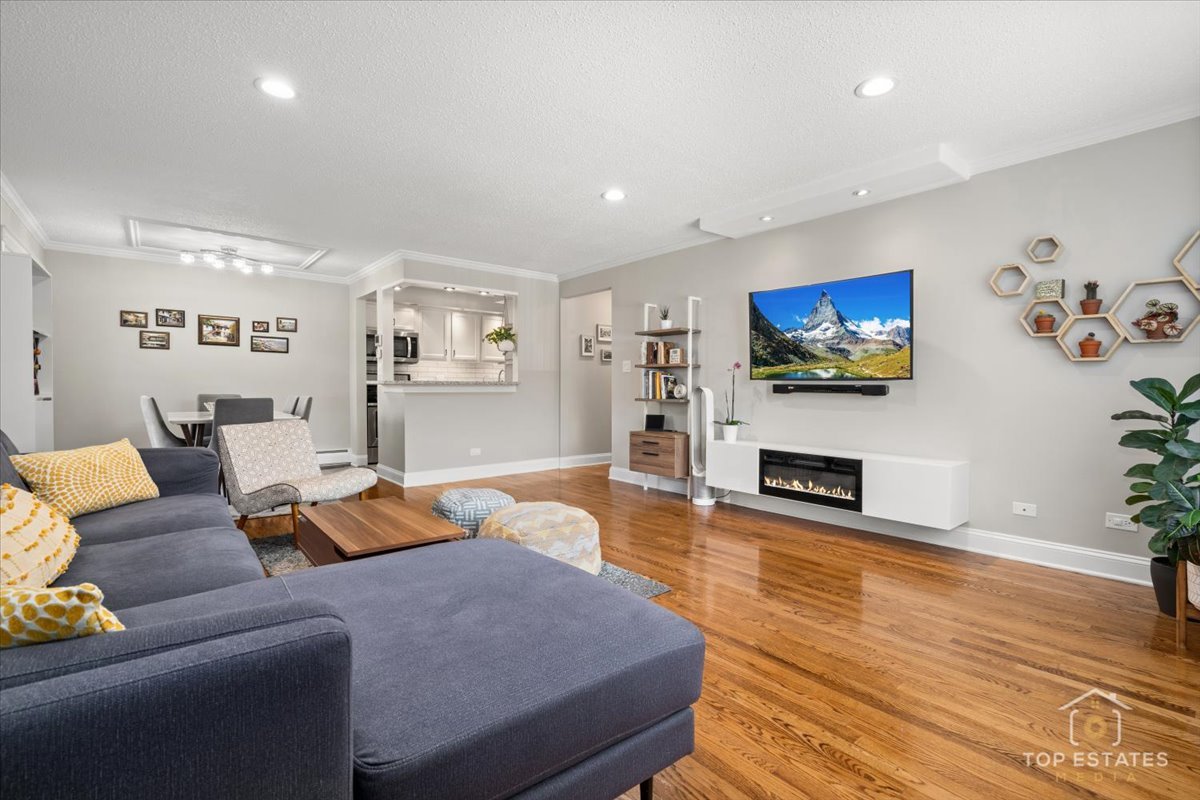 1227 South Old Wilke Road, Unit 201 Rolling Meadows, IL 60005 - Photo 13 of 40 a living room with furniture a flat screen tv and a fireplace