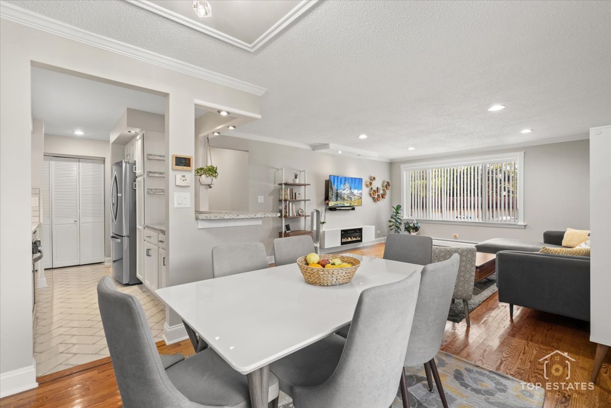 1227 South Old Wilke Road, Unit 201 Rolling Meadows, IL 60005 - Photo 17 of 40 a kitchen with stainless steel appliances a dining table chairs and a refrigerator