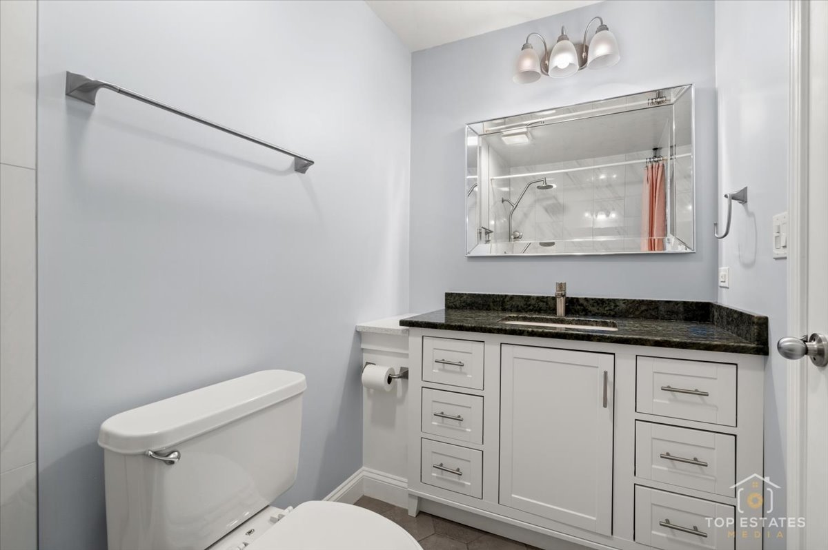 1227 South Old Wilke Road, Unit 201 Rolling Meadows, IL 60005 - Photo 21 of 40 a bathroom with a granite countertop sink a toilet and vanity