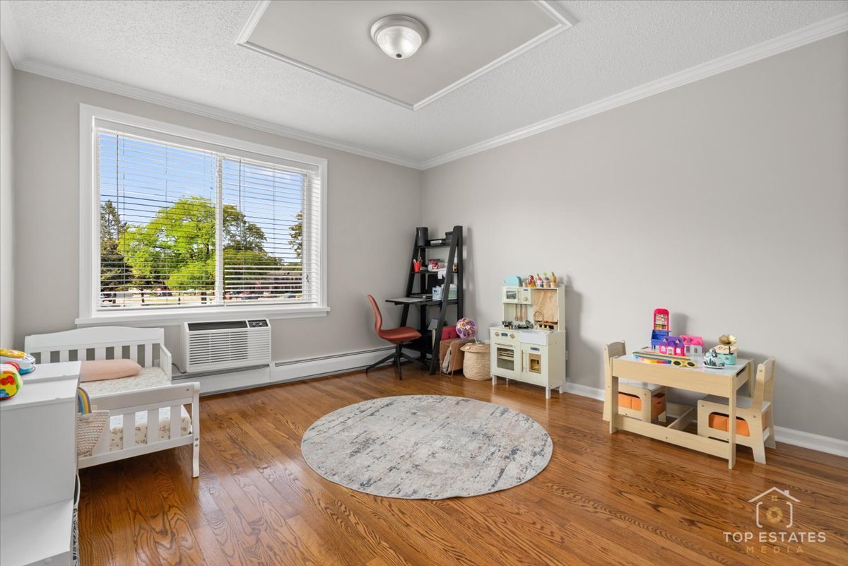 1227 South Old Wilke Road, Unit 201 Rolling Meadows, IL 60005 - Photo 23 of 40 a living room with furniture and a wooden floor