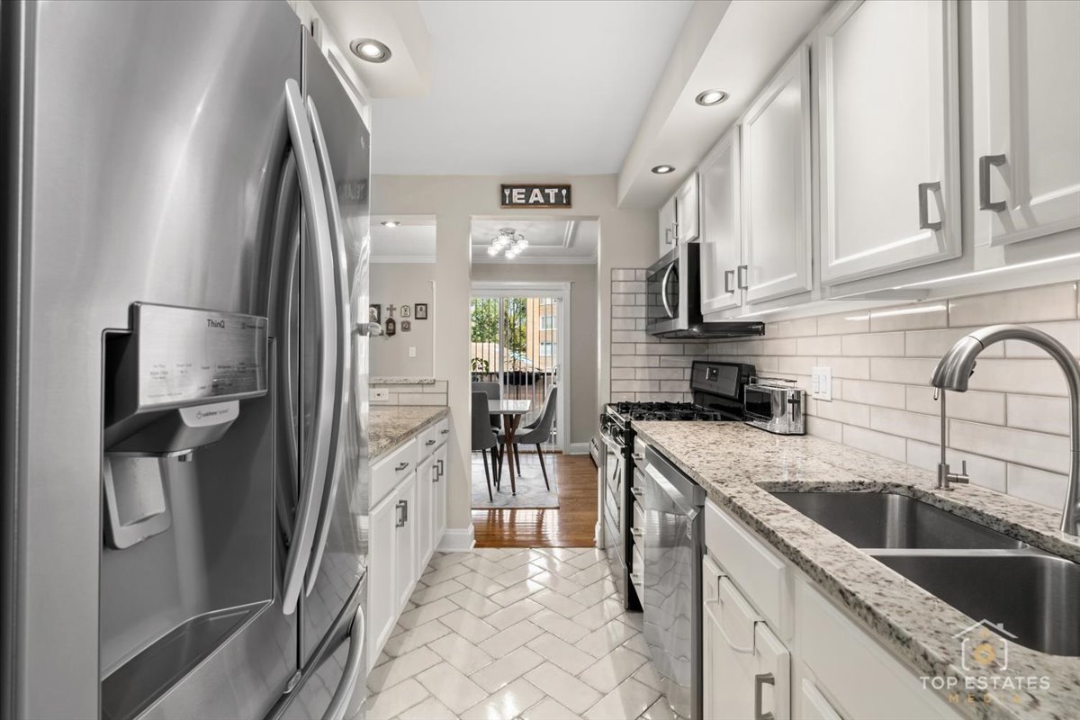 1227 South Old Wilke Road, Unit 201 Rolling Meadows, IL 60005 - Photo 8 of 40 a kitchen with stainless steel appliances granite countertop a refrigerator a stove and a sink with wooden floor