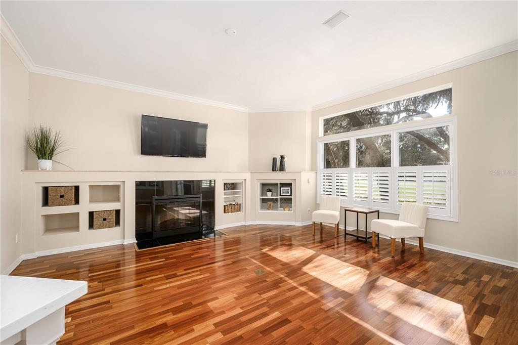 4417 Southwest 91st Drive Gainesville, FL 32608 - Photo 12 of 54 a living room with furniture a fireplace and a flat screen tv