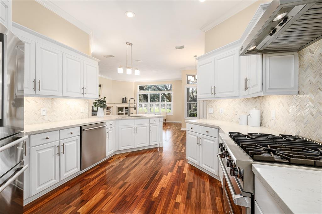 4417 Southwest 91st Drive Gainesville, FL 32608 - Photo 19 of 54 a kitchen with granite countertop white cabinets and white appliances