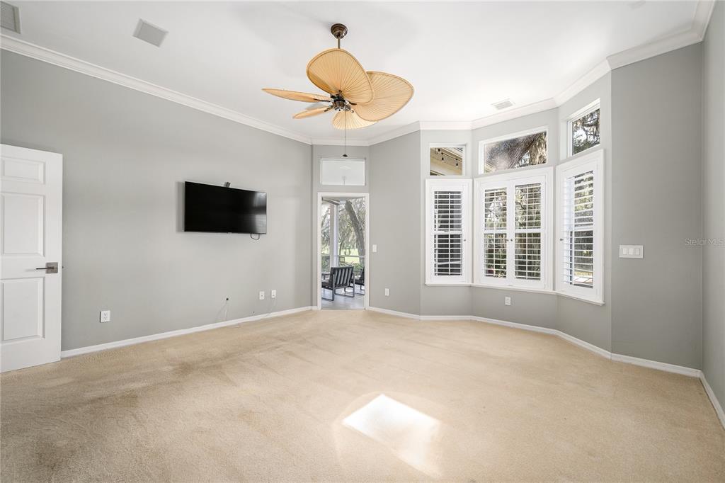 4417 Southwest 91st Drive Gainesville, FL 32608 - Photo 21 of 54 a view of a livingroom with wooden floor and a flat screen tv