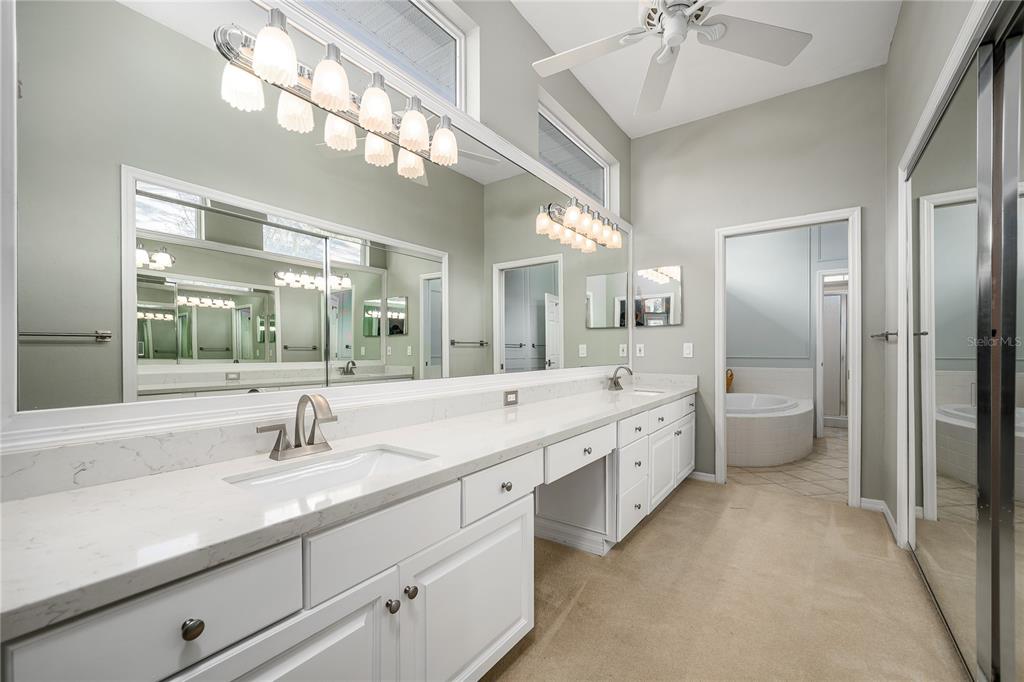 4417 Southwest 91st Drive Gainesville, FL 32608 - Photo 24 of 54 a large bathroom with a double vanity sink and a large mirror