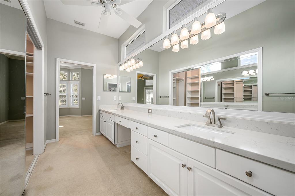 4417 Southwest 91st Drive Gainesville, FL 32608 - Photo 26 of 54 a spacious en suite bathroom with double sink and a large mirror