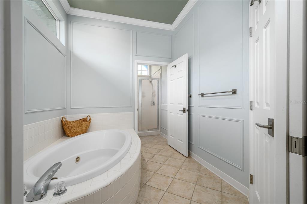 4417 Southwest 91st Drive Gainesville, FL 32608 - Photo 27 of 54 a bathroom with a tub and shower