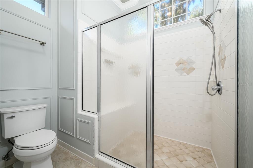 4417 Southwest 91st Drive Gainesville, FL 32608 - Photo 30 of 54 a bathroom with a granite countertop shower and a toilet