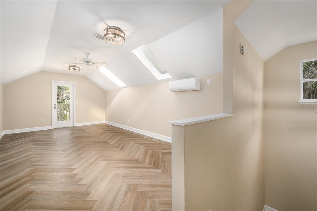 4417 Southwest 91st Drive Gainesville, FL 32608 - Photo 40 of 54 a view of a room with a window and wooden floor