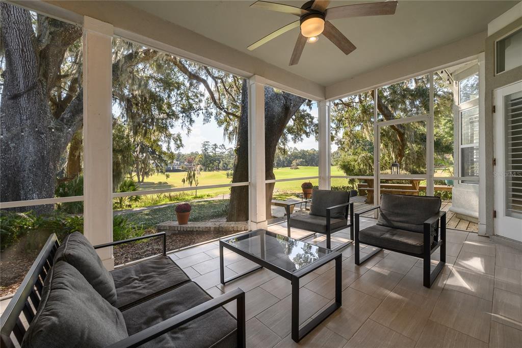 4417 Southwest 91st Drive Gainesville, FL 32608 - Photo 41 of 54 a living room with furniture and a floor to ceiling window