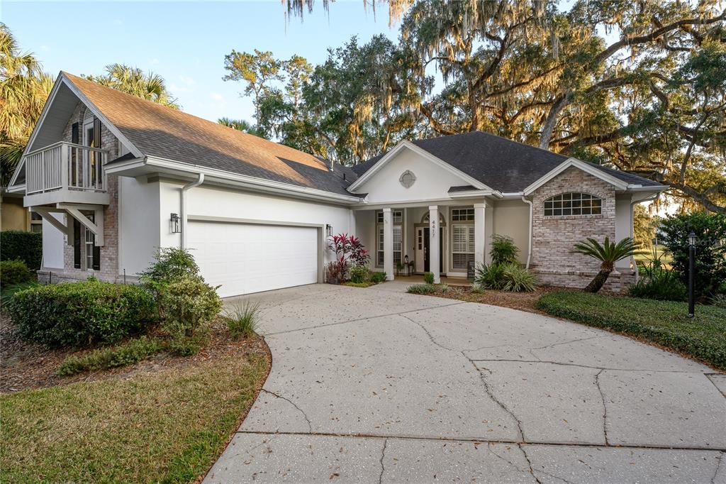 4417 Southwest 91st Drive Gainesville, FL 32608 - Photo 54 of 54 a front view of a house with a yard and garage