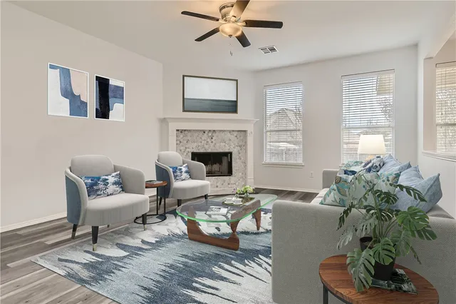 a living room with furniture fireplace and a window