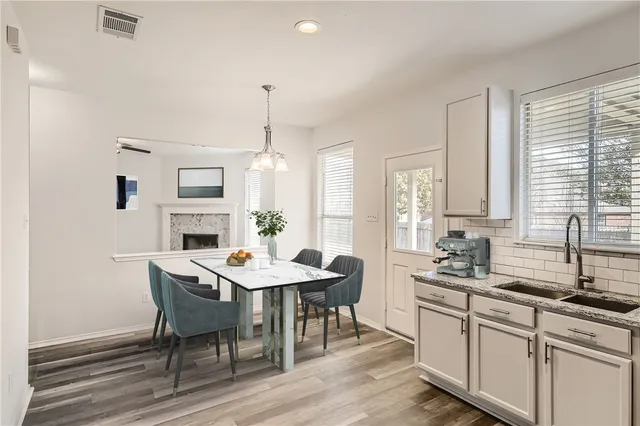 a view of a a dining room with furniture window and wooden floor