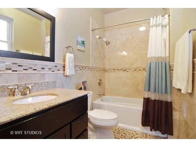 238 Lionel Road Riverside, IL 60546 - Photo 15 of 24 a bathroom with a granite countertop sink toilet a shower a mirror and bathtub